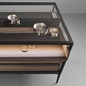 Close-up of glass top aluminium cabinet with wood finish and integrated lighting